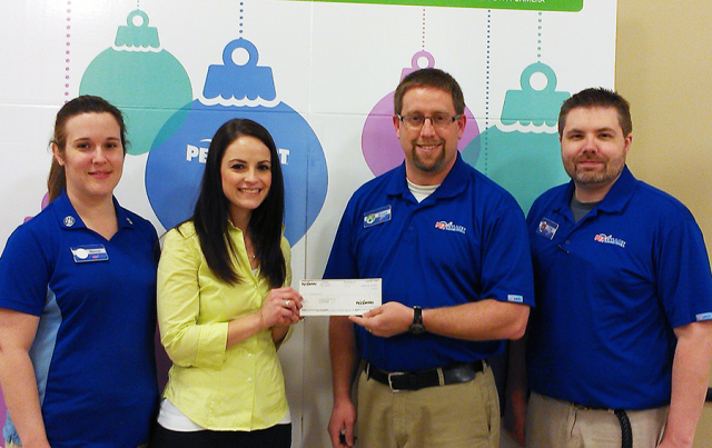 Jessica Marabella accepts a $2,000 donation on behalf of PAWS of CNY from PetSmart Store Manager Richard Merrill, Operations Manager Tom Lebeau and PAWS volunteer and PetSmart trainer, Melanie Hoover.